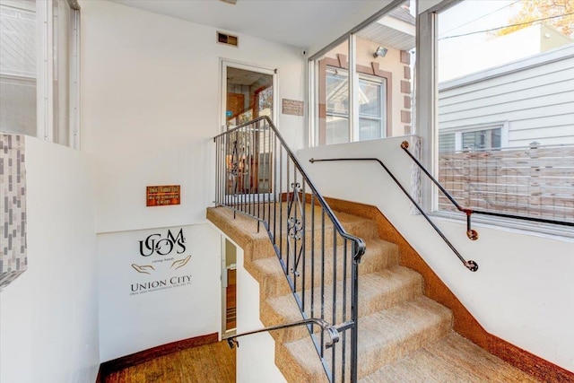 staircase with hardwood / wood-style floors