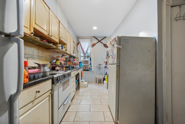 kitchen with white appliances and light tile patterned flooring