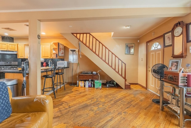509 81st St, North Bergen, NJ 07047 - entryway featuring stairway, light wood-type flooring, ornamental molding, healthy amount of natural light, and baseboards