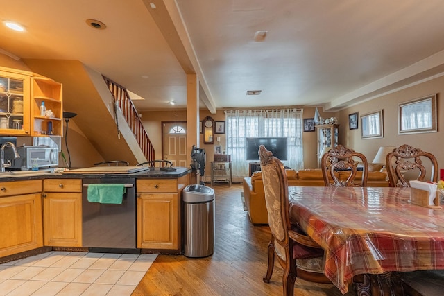 509 81st St, North Bergen, NJ 07047 - kitchen featuring stainless steel appliances, plenty of natural light, dark countertops, and light wood finished floors