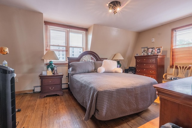 509 81st St, North Bergen, NJ 07047 - bedroom featuring wood finished floors and a baseboard heating unit