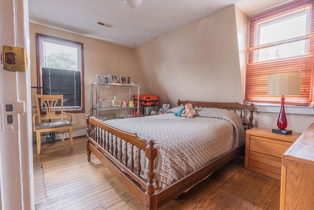 509 81st St, North Bergen, NJ 07047 - bedroom featuring multiple windows, hardwood / wood-style floors, and baseboard heating