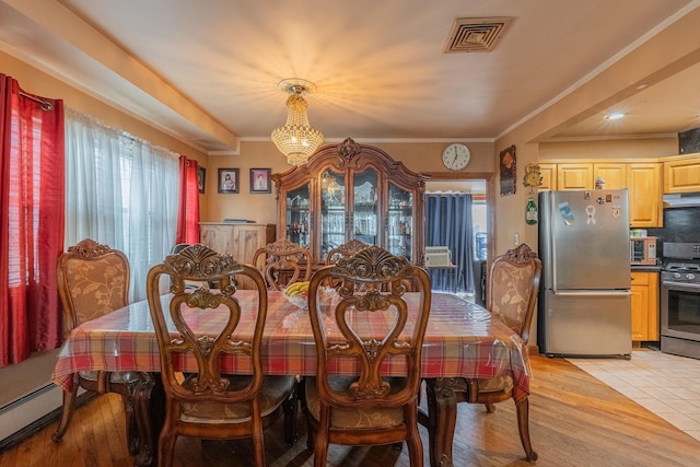 509 81st St, North Bergen, NJ 07047 - dining area featuring a chandelier, a baseboard radiator, ornamental molding, and light wood finished floors
