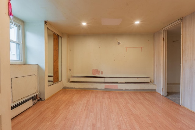 509 81st St, North Bergen, NJ 07047 - spare room featuring baseboard heating, wood finished floors, recessed lighting, and a baseboard heating unit
