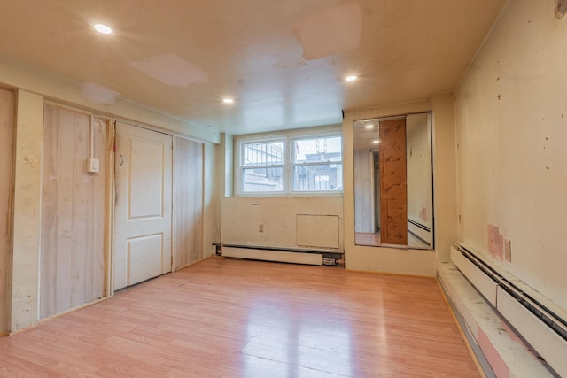 509 81st St, North Bergen, NJ 07047 - unfurnished bedroom with a baseboard radiator, light wood-style flooring, and recessed lighting