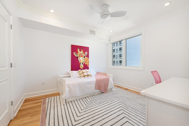 bedroom with visible vents, crown molding, baseboards, recessed lighting, and light wood-style flooring