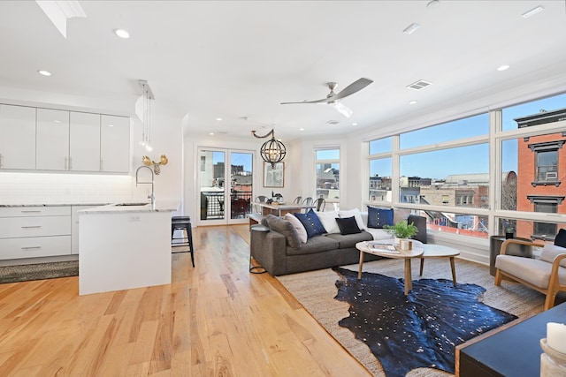 living room featuring visible vents, recessed lighting, light wood-style floors, and ceiling fan