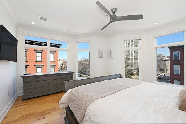 bedroom with baseboards, visible vents, recessed lighting, ornamental molding, and light wood-style floors