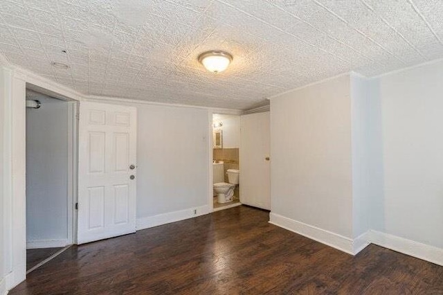 unfurnished room with baseboards and wood finished floors