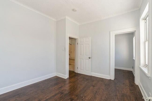 unfurnished bedroom featuring baseboards and wood finished floors