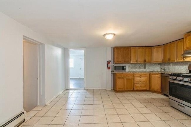kitchen featuring brown cabinetry, backsplash, a baseboard heating unit, and stainless steel appliances