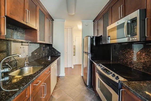 100 Manhattan Ave Unit 2010, Union City, NJ 07087 - kitchen featuring appliances with stainless steel finishes, tasteful backsplash, tile patterned flooring, and dark stone counters