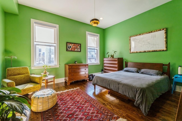 bedroom with recessed lighting, wood finished floors, and baseboards