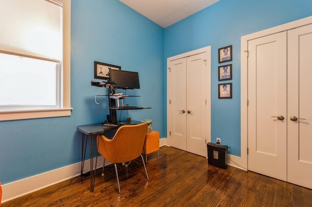 home office featuring baseboards and wood finished floors