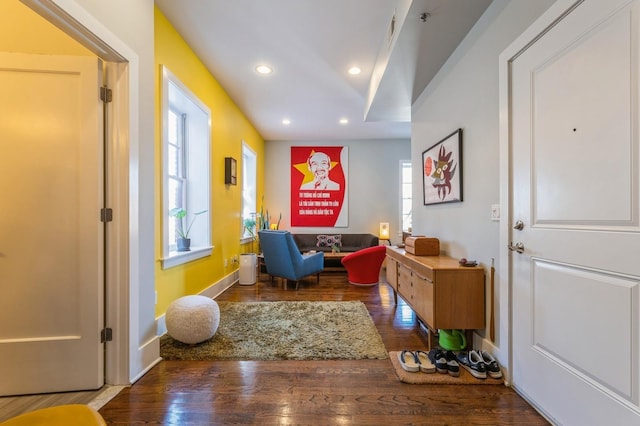 living area featuring recessed lighting, baseboards, and wood finished floors