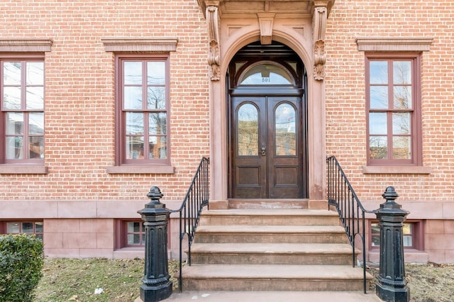 doorway to property with french doors and brick siding