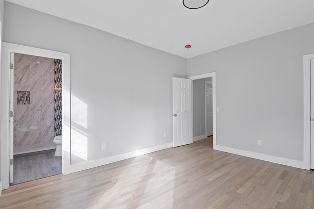 95 Claremont Ave, Jersey City, NJ 07304 - unfurnished bedroom with light wood finished floors and ensuite bath