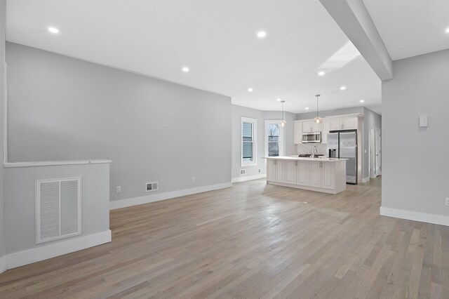 95 Claremont Ave, Jersey City, NJ 07304 - unfurnished living room featuring light wood finished floors and recessed lighting