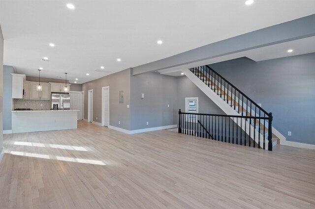 95 Claremont Ave, Jersey City, NJ 07304 - unfurnished living room featuring recessed lighting, light wood finished floors, and stairway