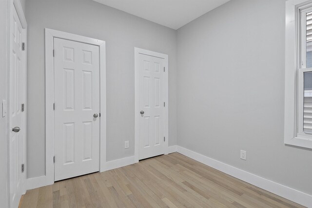 95 Claremont Ave, Jersey City, NJ 07304 - unfurnished bedroom with light wood-type flooring and baseboards