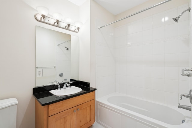 bathroom with shower / washtub combination, vanity, and toilet