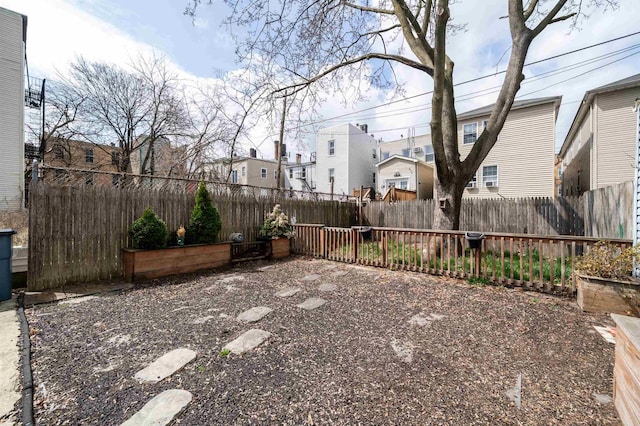 view of yard featuring fence and a residential view