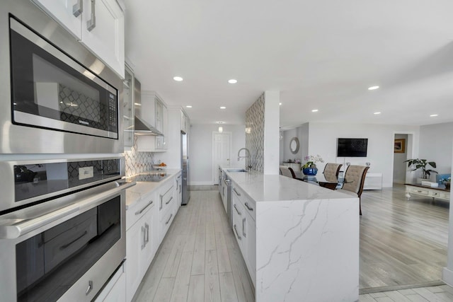 200 Winston Dr Unit 2502, Cliffside Park, NJ 07010 - kitchen featuring light wood-style floors, appliances with stainless steel finishes, and white cabinetry