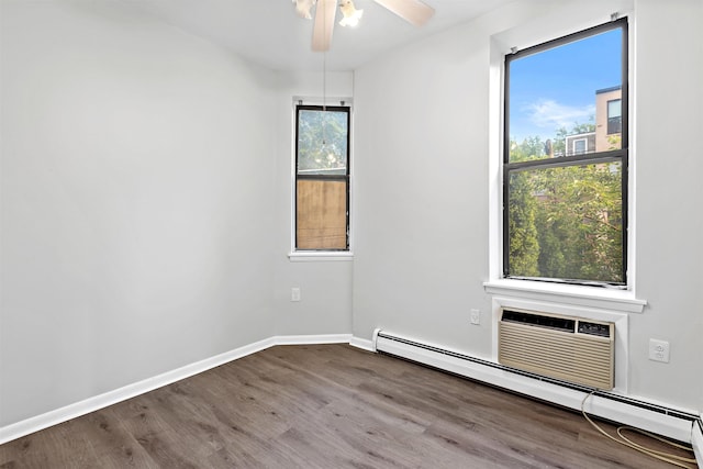 263 10th St Unit 2D, Jersey City, NJ 07302 - unfurnished room featuring a baseboard radiator, wood finished floors, a ceiling fan, and baseboards