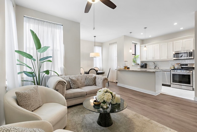 263 10th St Unit 2D, Jersey City, NJ 07302 - living area with plenty of natural light, light wood-style floors, ceiling fan, recessed lighting, and baseboards