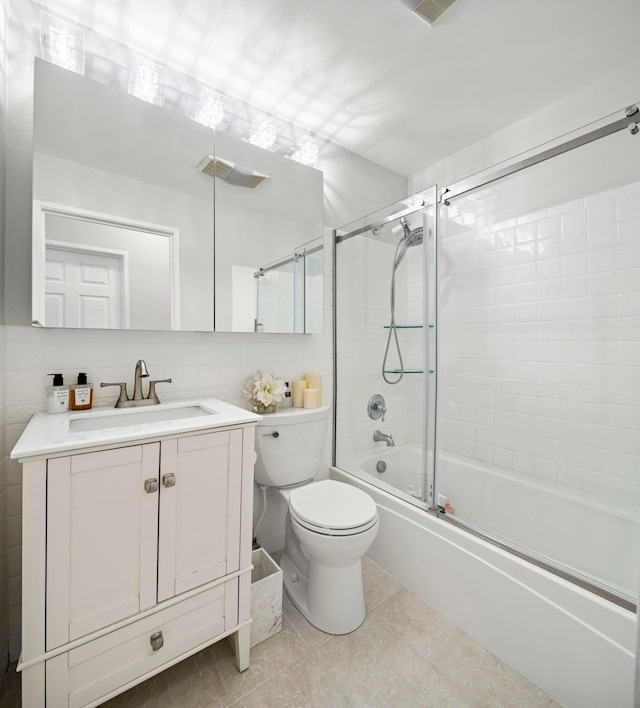 263 10th St Unit 2D, Jersey City, NJ 07302 - full bath with enclosed tub / shower combo, vanity, toilet, tile walls, and tile patterned floors