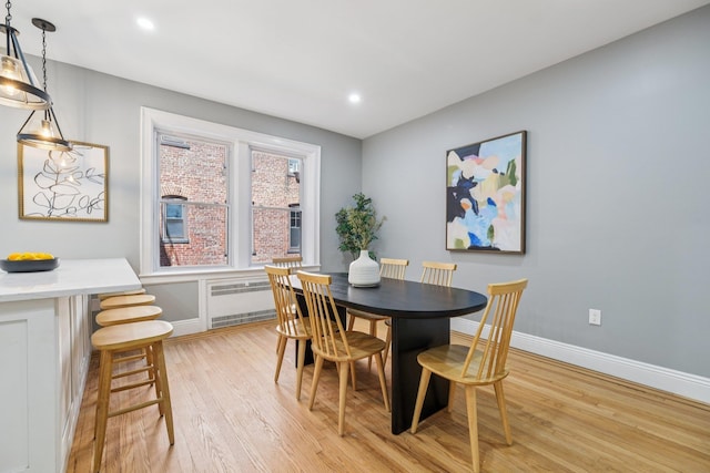 340 Fairmount Ave Apt 209, Jersey City, NJ 07306 - dining space with radiator heating unit, light wood-style floors, and recessed lighting