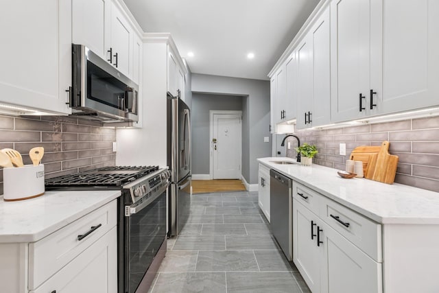 340 Fairmount Ave Apt 209, Jersey City, NJ 07306 - kitchen with appliances with stainless steel finishes, recessed lighting, white cabinetry, decorative backsplash, and light stone counters
