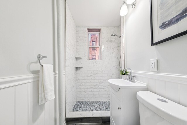 340 Fairmount Ave Apt 209, Jersey City, NJ 07306 - bathroom with vanity, a stall shower, a wainscoted wall, and a decorative wall
