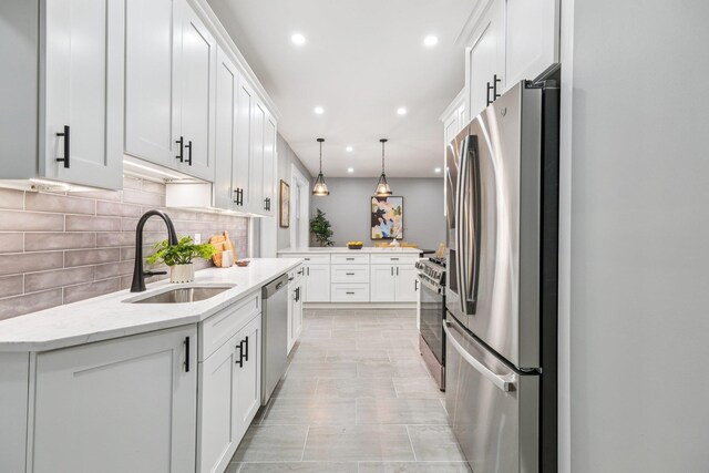 340 Fairmount Ave Apt 209, Jersey City, NJ 07306 - kitchen with stainless steel appliances, recessed lighting, tasteful backsplash, white cabinets, and hanging light fixtures