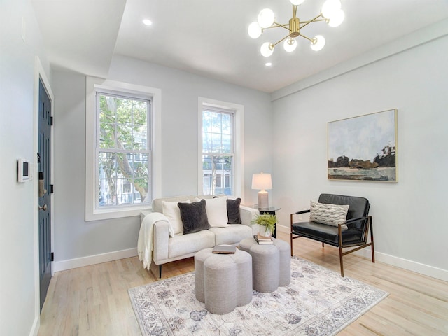 living room with a chandelier and light wood-type flooring