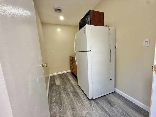 201 Livingston Ave, New Brunswick, NJ 08901 - kitchen with freestanding refrigerator, dark wood-style flooring, baseboards, and brown cabinetry