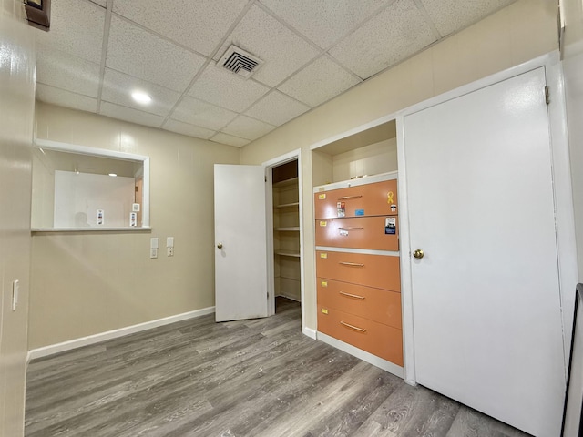201 Livingston Ave, New Brunswick, NJ 08901 - unfurnished bedroom featuring wood finished floors, a paneled ceiling, and baseboards