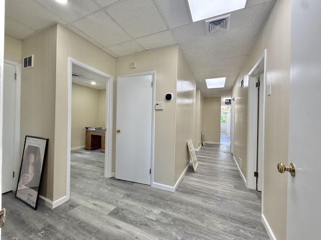 201 Livingston Ave, New Brunswick, NJ 08901 - hall featuring wood finished floors, baseboards, a skylight, and a paneled ceiling