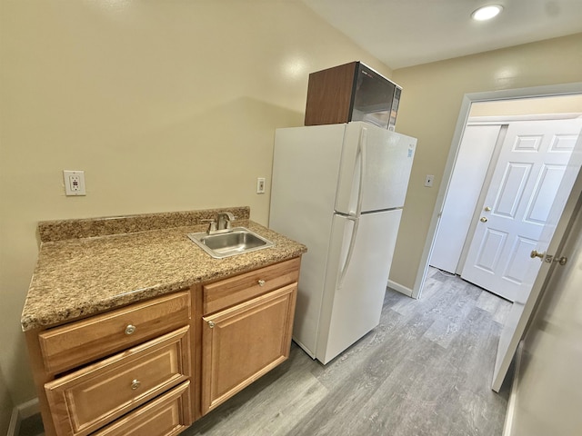 201 Livingston Ave, New Brunswick, NJ 08901 - kitchen featuring freestanding refrigerator, a sink, light wood finished floors, light countertops, and recessed lighting