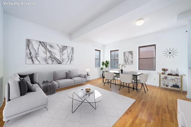 living room featuring wood-type flooring and beamed ceiling