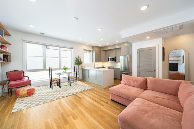 384 7th St Unit 5, Jersey City, NJ 07302 - living room featuring light wood-style flooring, arched walkways, and recessed lighting