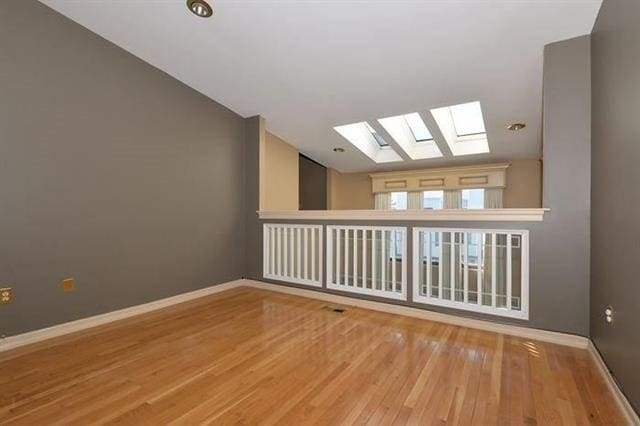 750 Mainsail Ln, Secaucus, NJ 07094 - additional living space with baseboards, wood finished floors, and lofted ceiling with skylight