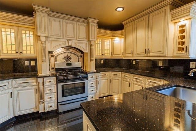 750 Mainsail Ln, Secaucus, NJ 07094 - kitchen with glass insert cabinets, tasteful backsplash, gas stove, and a sink