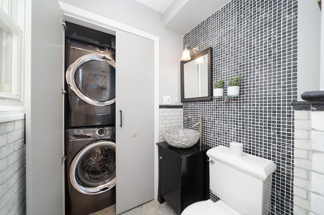 78 Madison St Unit 2, Hoboken, NJ 07030 - bathroom with stacked washer and clothes dryer, tile walls, and vanity