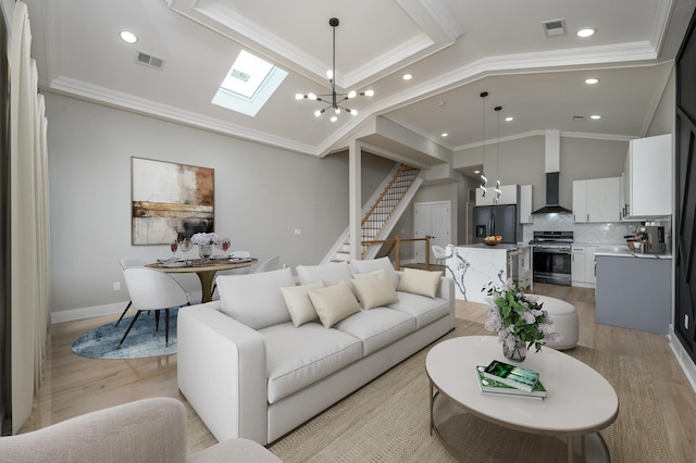 living area featuring stairway, light wood-style floors, visible vents, and ornamental molding