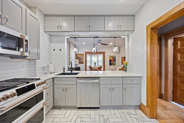 138 Kensington Ave Unit 3, Jersey City, NJ 07304 - kitchen featuring tasteful backsplash, appliances with stainless steel finishes, gray cabinets, and a sink