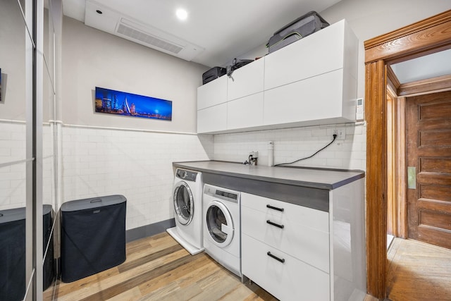 138 Kensington Ave Unit 3, Jersey City, NJ 07304 - laundry room with wainscoting, light wood-style floors, tile walls, washer and dryer, and visible vents
