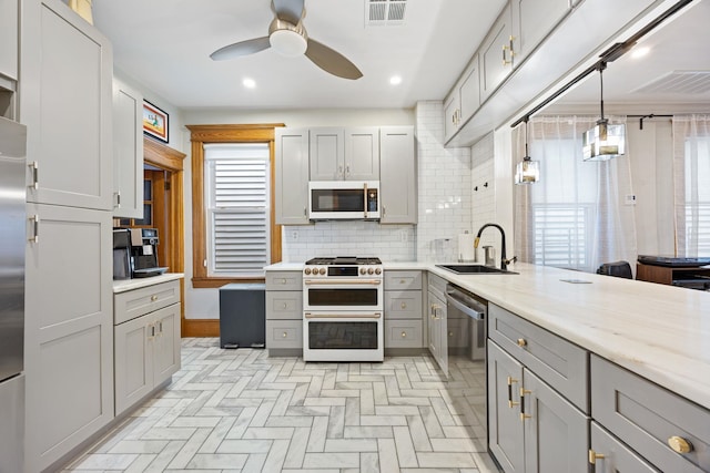 138 Kensington Ave Unit 3, Jersey City, NJ 07304 - kitchen featuring a ceiling fan, a sink, appliances with stainless steel finishes, gray cabinetry, and visible vents