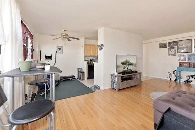 living room featuring ceiling fan and light hardwood / wood-style flooring