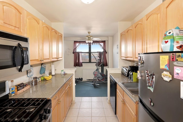 kitchen with ceiling fan, light tile patterned flooring, light brown cabinetry, and appliances with stainless steel finishes